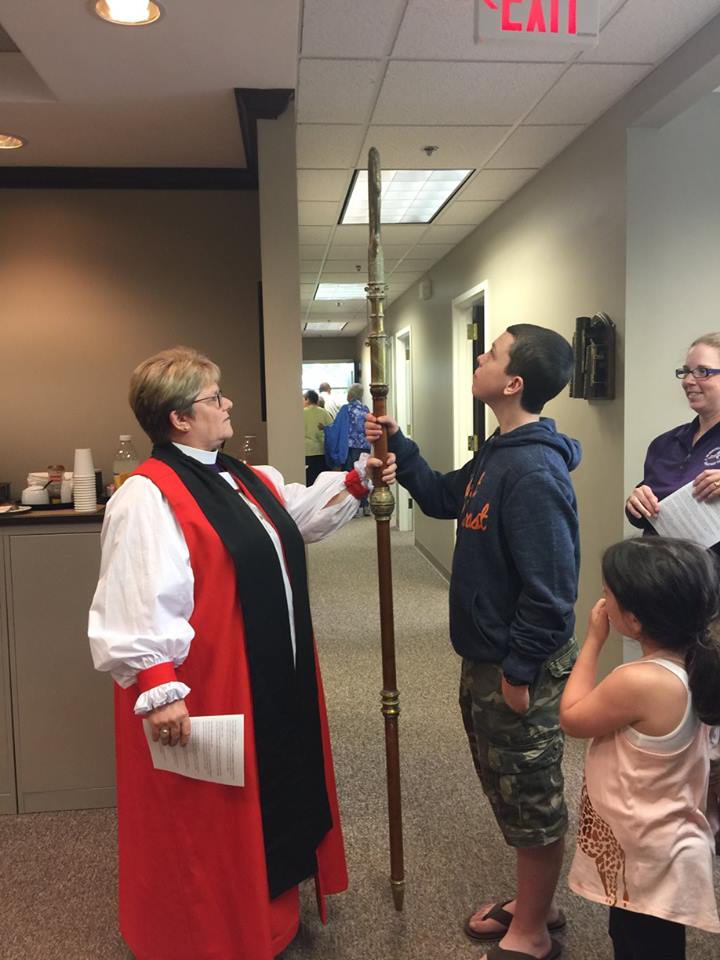 Bishop DeDe teaches Lambros and Molly Alamond about the first crozier ever used by the Episcopal Diocese of CNY. 