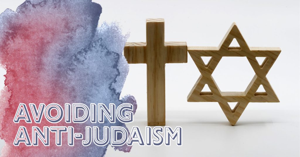 The left side of the image is an abstract red and blue watercolor splotch, over which it reads "AVOIDING ANTI-JUDAISM." The watercolor splotch fades into a neutral background with a simple wooden cross and Star of David.